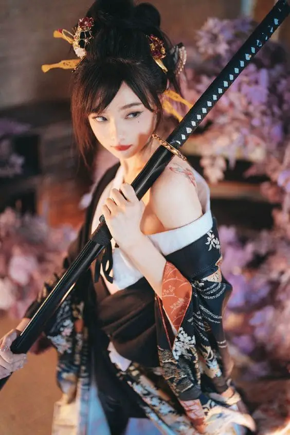 exposed shoulder while holding a katana pose