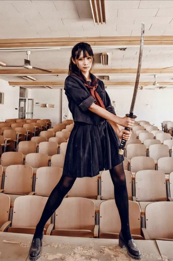 girl posing with a waist level katana sword hold