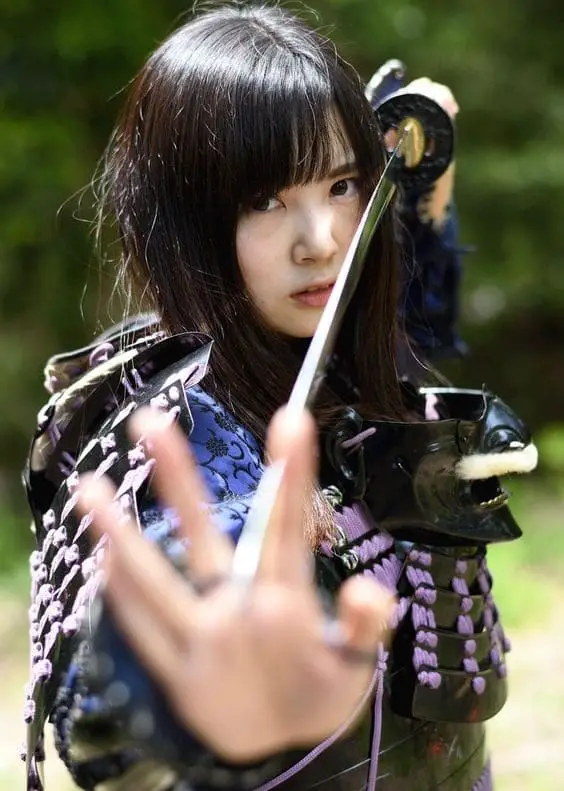 girl posing with katana sword between fingers